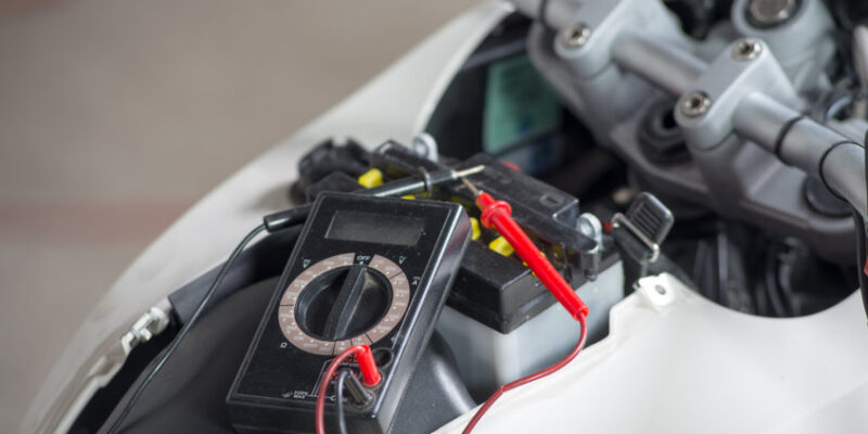 a testing the battery of the motorcycle